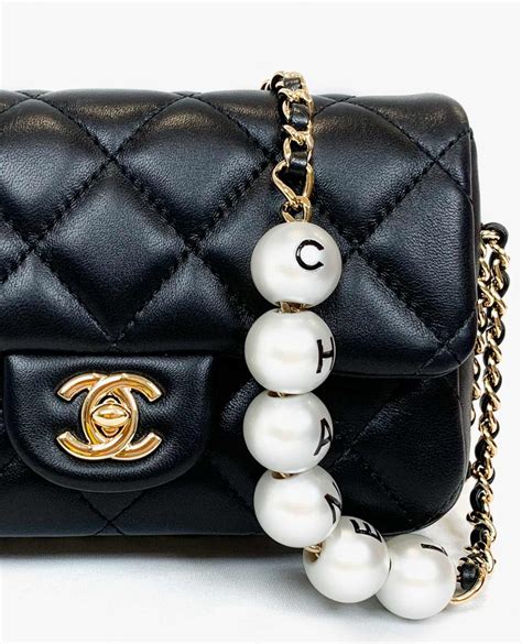 chanel small bag with pearl chain|Chanel bag with pearls strap.